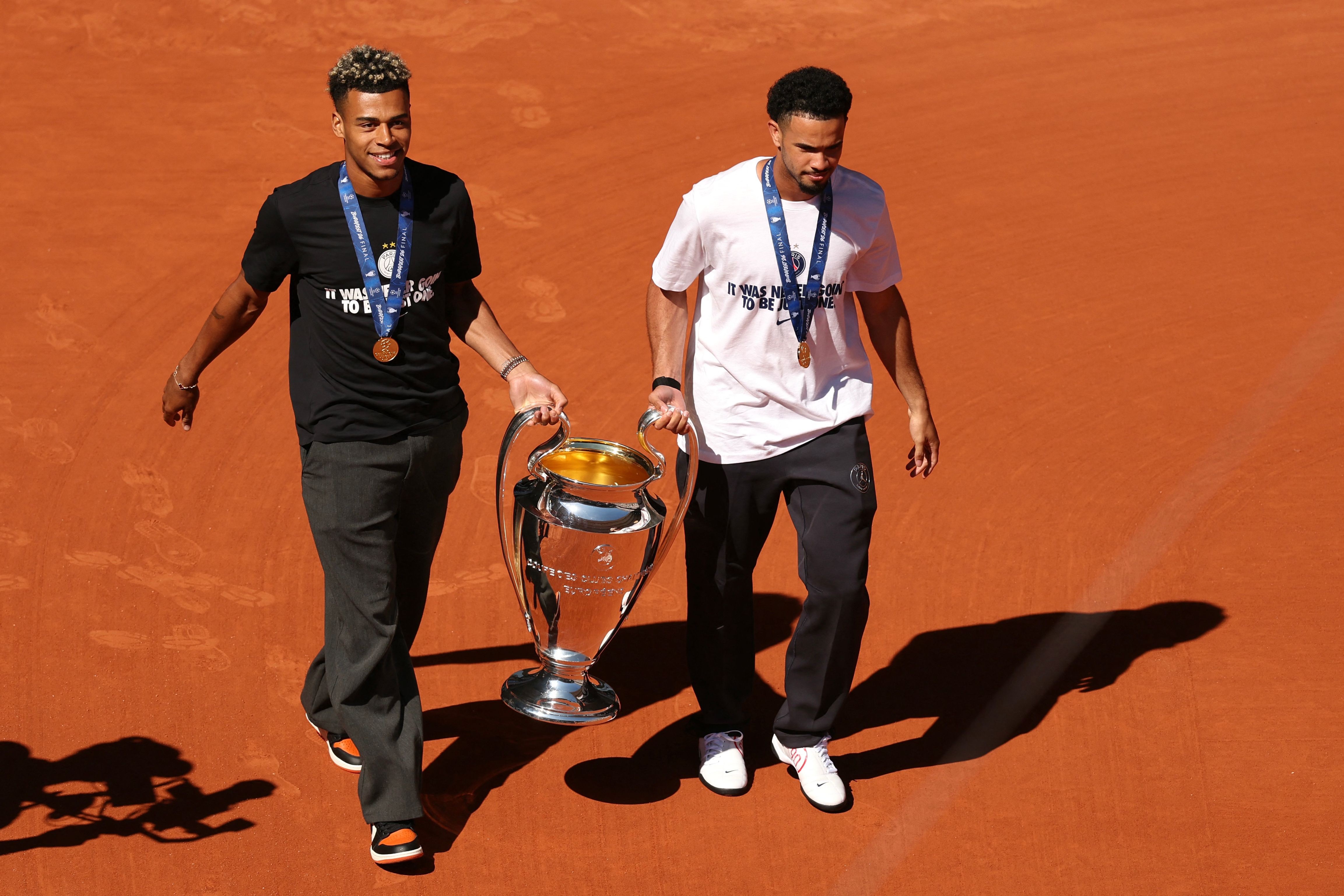 Jogadores do PSG dão volta olímpica com taça da Liga dos Campeões na quadra principal de Roland Garros