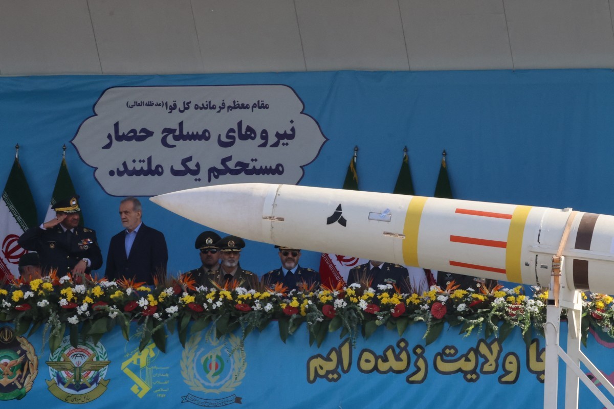 O presidente do Irã, Masoud Pezeshkian, observa enquanto um míssil 'Sayyad' é exibido durante o desfile militar anual que marca o aniversário da eclosão da guerra de 1980-1988 com o Iraque de Saddam Hussein, em Teerã, em 21 de setembro de 2024 — Foto: ATTA KENARE / AFP