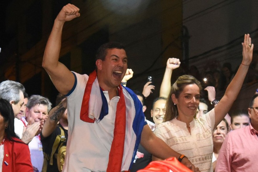 Santiago Peña (centro), candidato do Partido Colorado, celebra vitória eleitoral ao lado de sua mulher, Leticia Ocampos de Pea, em Assunção — Foto: DANIEL DUARTE / AFP