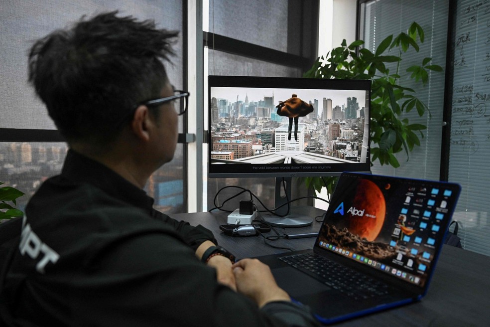 Chen Kun, founder of AIpai, in his office in Beijing. One of his very short video series filled with dragon-like monsters, cutesy heroes and lots of melodrama - Photograph: Pedro Pardo/AFP
