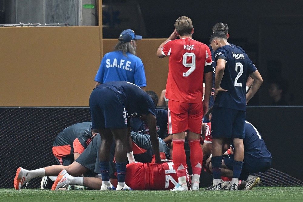Kane, do Bayern, e Hakimi, do PSG, demonstram preocupação com a lesão de Musiala — Foto: Paul ELLIS / AFP
