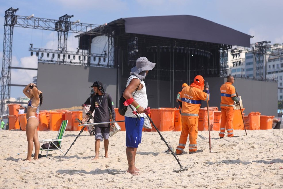Trabalho dos detectoristas foi simultâneo ao serviço de limpeza da Comlurb, na frente do palco do show da Lady Gaga — Foto: Marcia Foletto