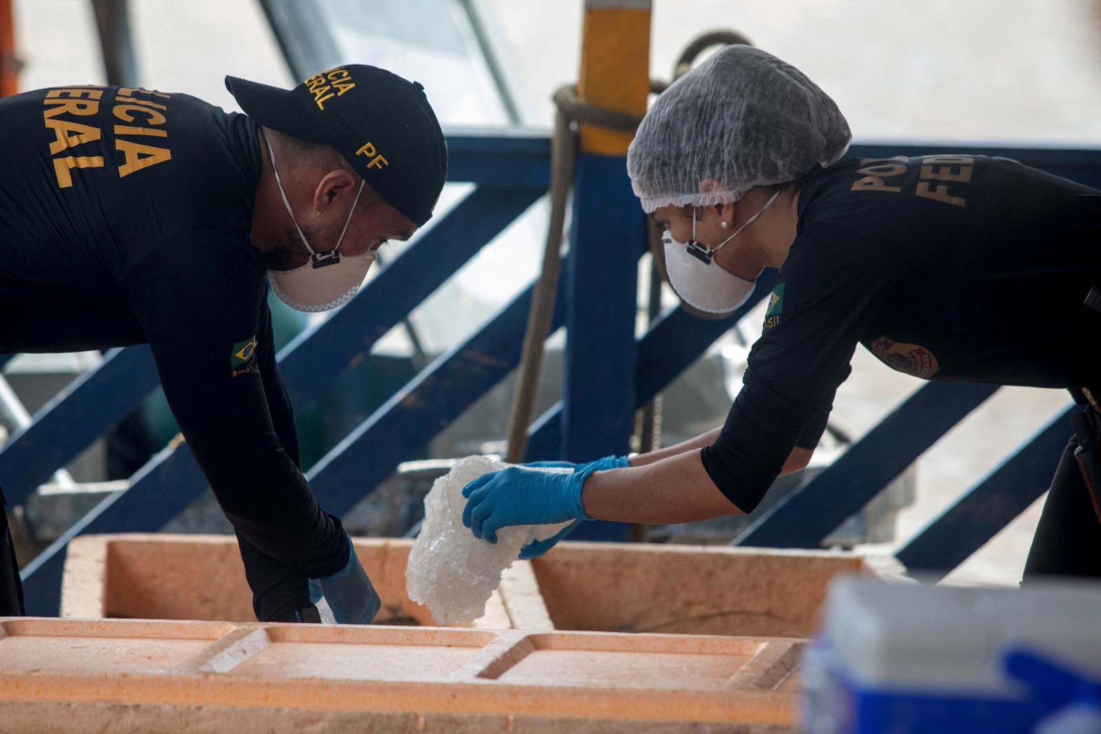Peritos da Polícia Federal examinam um barco apreendido em Atalaia do Norte. Força tarefa investiga sinais de escavações em uma área próxima ao local onde jornalista e indigenista foram vistos pela última vez.  — Foto: JOAO LAET / AFP