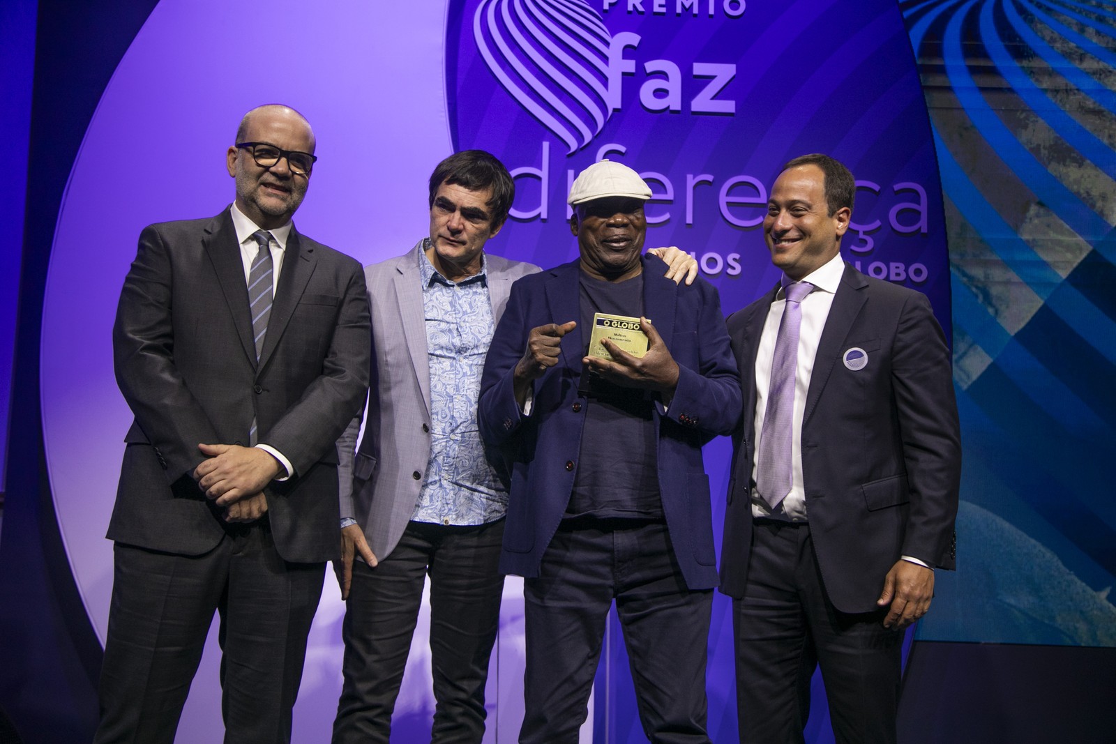 O músico Milton Nascimento recebe o prêmio de Personalidade 2022 das mãos do diretor-presidente da TV Globo, Paulo Marinho, do diretor de redação de O GLOBO, Alan Gripp, e do músico Samuel Rosa      — Foto: Guito Moreto