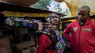 David Gathu e Moses Kiuna demonstram a operação de uma prótese biorrobótica — Foto: Tony KARUMBA / AFP