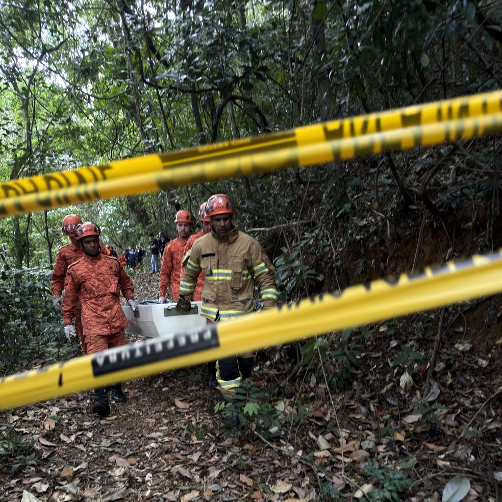 Um dos corpos é retirado da mata após queda do helicóptero na Vista Chinesa — Foto: Ana Branco/Agência O Globo