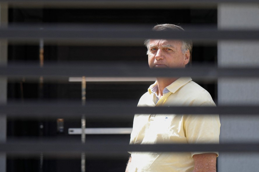 Former Brazilian President Jair Bolsonaro gestures from his residence in Brasilia on September 3, 2025. Brazil's Supreme Court on Tuesday began verdict deliberations in the trial of former president Jair Bolsonaro, who is accused of plotting a coup to attempt to retain power after he lost the 2022 election.
