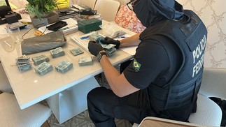 Agente da PF apreende dinheiro de integrante de quadrilha de tráfico de drogas — Foto: Divulgação/PF