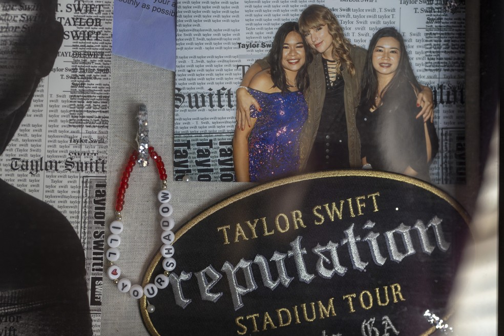Uma foto de Chricket Cho e sua mãe, Thippy Cho, com Taylor Swift, uma pulseira de amizade e lembranças da turnê Reputation em exibição em sua casa em Suwanee, Geórgia, 27 de fevereiro de 2025. — Foto: Audra Melton / The New York Times