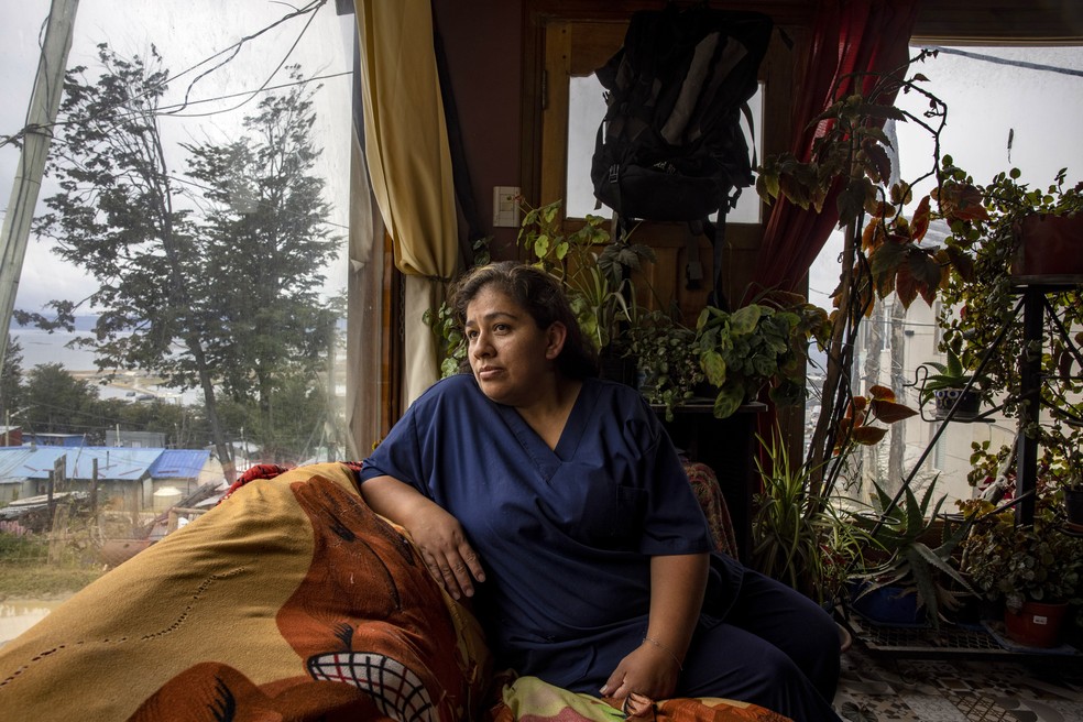 Nolly Ramos León, 34, trabalha como arrumadeira num hotel de luxo em Ushuaia para criar os quatro filhos, com quem mora num bairro precário nos arredores da cidade mais austral do mundo — Foto: Victor Moriyama/The New York Times