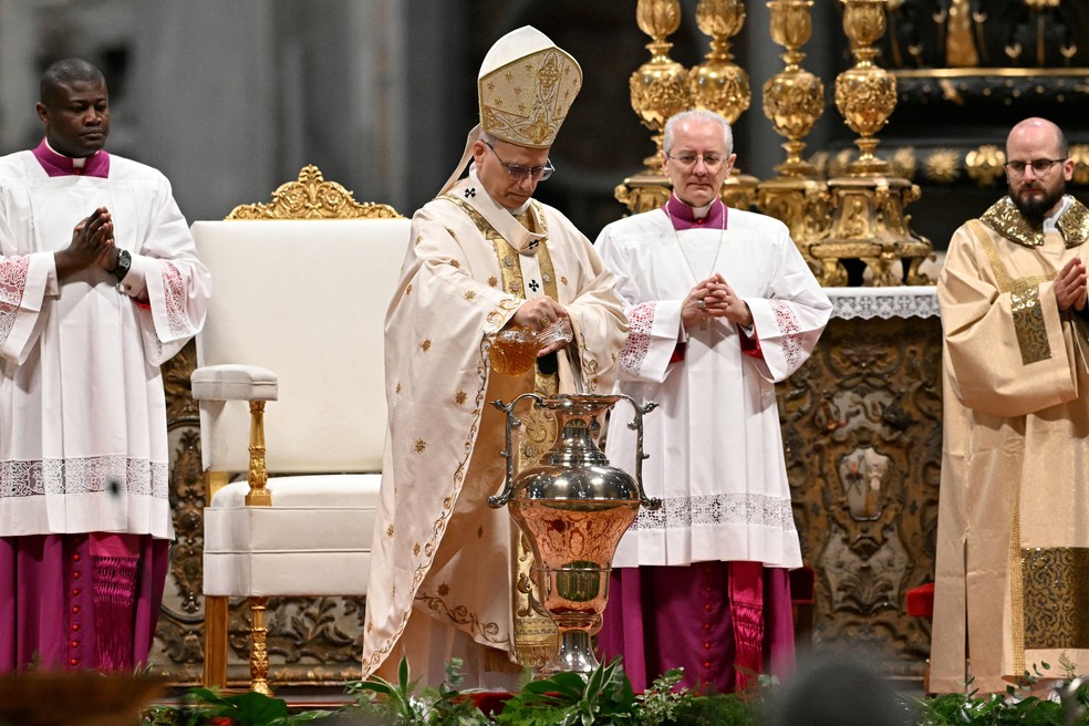 Papa Leão XIV derrama perfume numa ânfora contendo óleo sagrado durante a Missa Crismal da Quinta-feira Santa na Basílica de São Pedro, no Vaticano, em 2 de abril de 2026 — Foto: Tiziana FABI / AFP