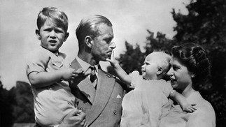 A rainha Elizabeth II e seu marido, o príncipe Philip, duque de Edimburgo, posam com seus dois filhos, Charles, príncipe de Gales (à esquerda) e a princesa Anne  — Foto: AFP