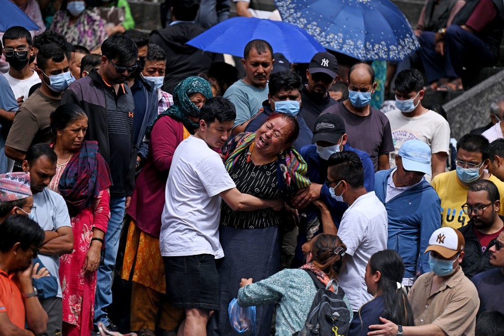 Familiares lamentam durante funerais simb&oacute;licos realizados para v&iacute;timas das enchentes ainda desaparecidas, enquanto cremavam ef&iacute;gies de capim Kush de acordo com os ritos hindus nepaleses no templo Pashupatinath em Katmandu, em 2 de setembro de 2026 &mdash; Foto: PRAKASH MATHEMA / AFP