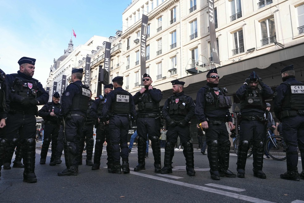 Policiais protegem a entrada da nova loja da Shein em Paris — Foto: Dimitar Dilkoff/AFP