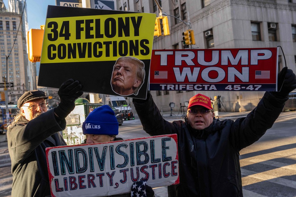 Apoiadores e opositores de Donald Trump protestam enquanto é lido o veredicto contra o presidente eleito dos EUA - Foto: Adam Gray/Getty Images/AFP