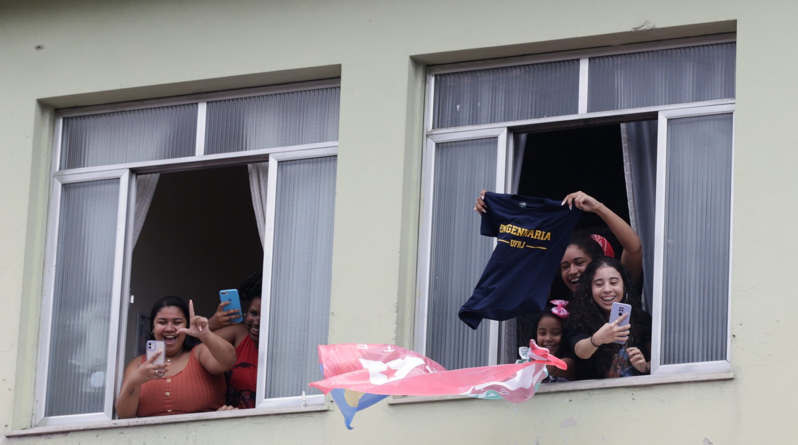 Moradora Complexo do Alemão exibe camisa do curso de Engenharia da UFRJ em apoio à candidatura de Lula — Foto: Domingos Peixoto/Agência O Globo