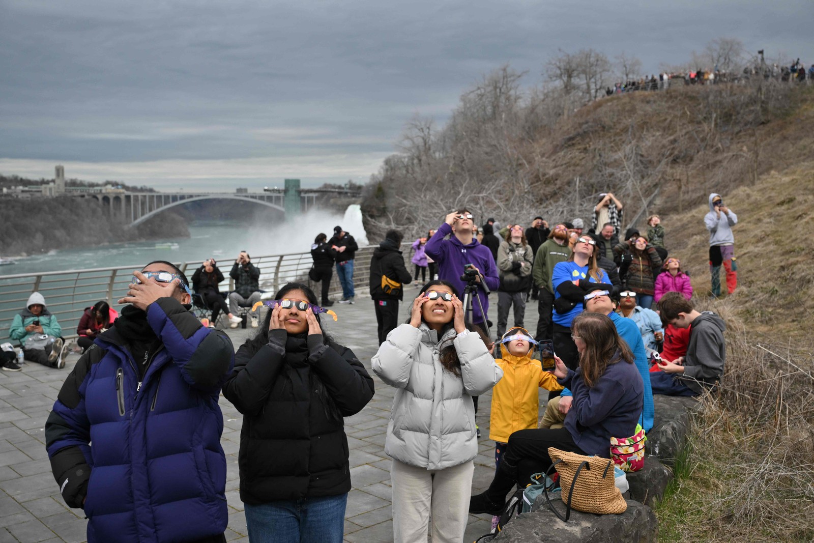 Pessoas Olham Para O Sol Durante Eclipse Solar Total No Niagara Falls State Park, Em Nova York. - Foto: Angela Weiss/AFP