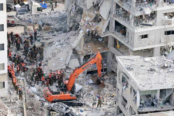 111423139-israeli-rescuers-search-through-the-rubble-at-the-site-of-an-overnight-iranian-missile.jpg