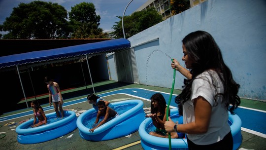 Escola cria 'recreio molhado' com banho de mangueira para amenizar o calor em Brasília 