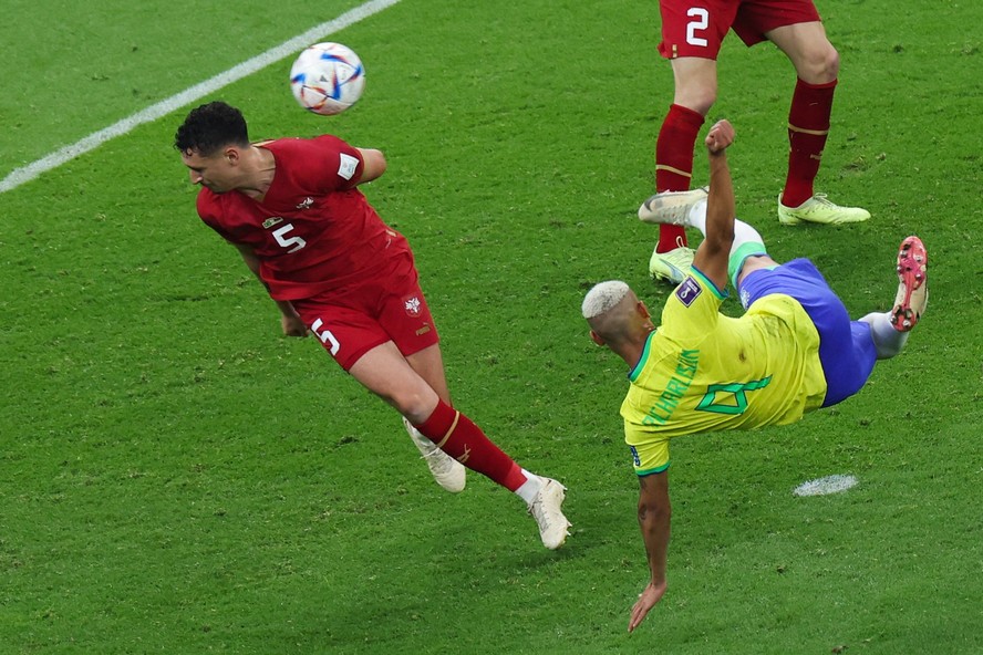 Richarlison acerta a bola ao lado do zagueiro sérvio Milos Veljkovic antes de marcar o segundo gol do Brasil