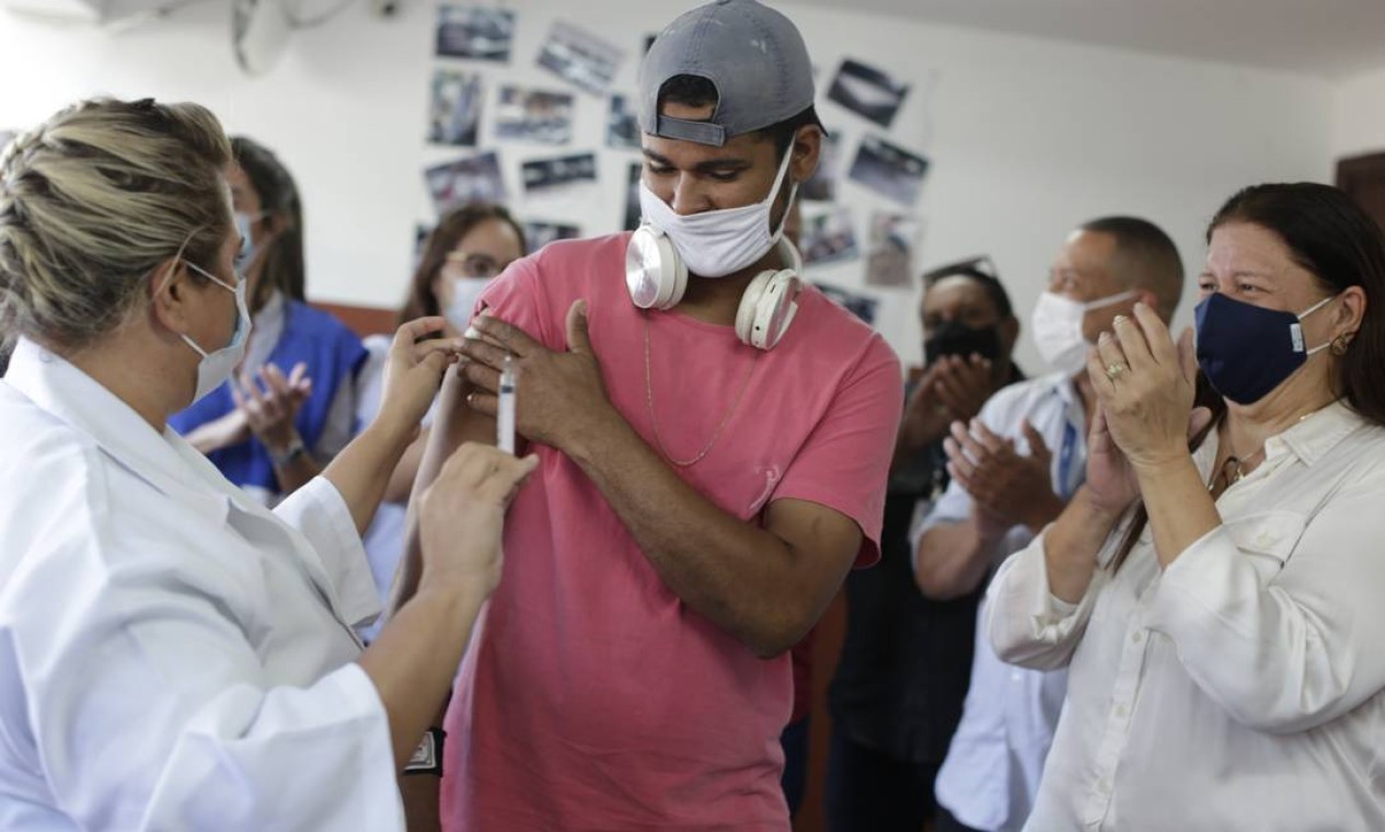 Jovem em situação de rua acolhido por unidade municipal na Taquara, na Zona Oeste, é aplaudido ao ser vacinado contra Covid-19 — Foto: Marcia Foletto em 25/05/2021 / Agência O Globo