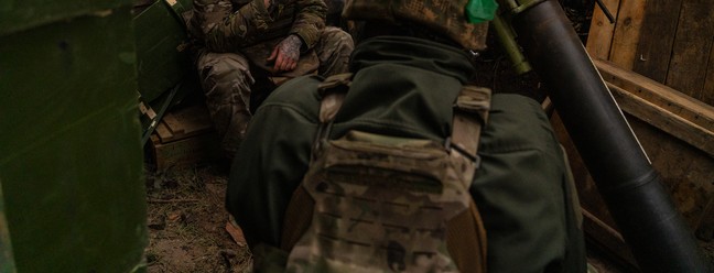 Soldados ucranianos aguardam ordens para disparar contra posições russas distantes apenas três quilômetros dali. Com a escassez de munições, os soldados passam horas e horas aguardando ordens para disparar. Foto tirada na Floresta de Kremina, Oblast de Donetsk, Ucrânia — Foto: Yan Boechat
