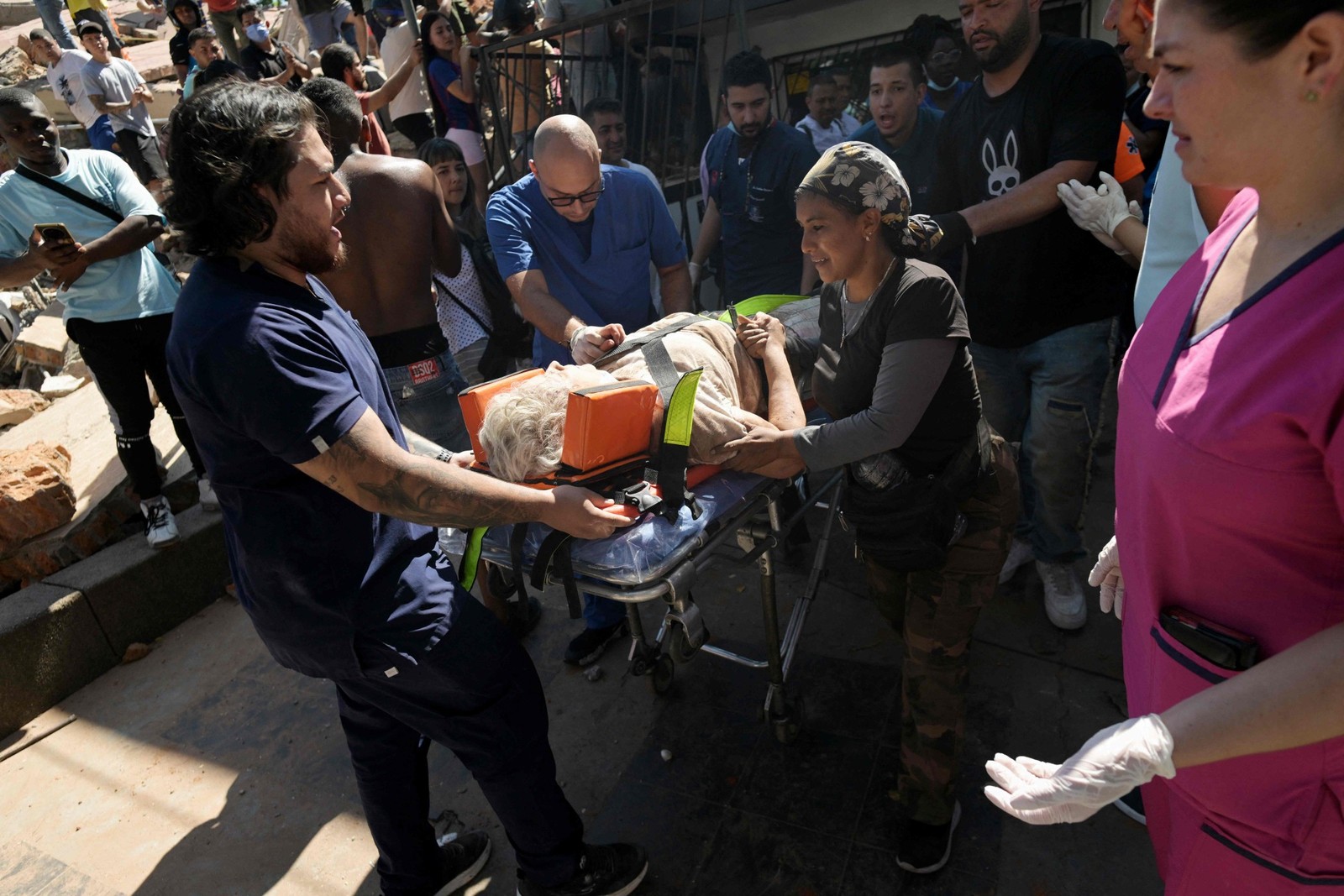 Uma mulher é transportada em uma maca após ser resgatada de um edifício desabado devido a um terremoto em Cali, Colômbia. — Foto: JOAQUIN SARMIENTO / AFP