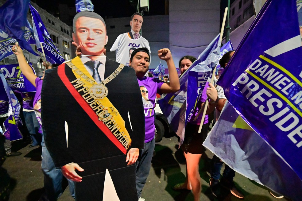 Apoiador de Daniel Noboa carrega imagem em tamanho real do presidente — Foto: Marcos Pin/AFP