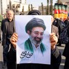 Mulher mostra imagem de Mojtaba Khamenei, novo líder supremo do Irã, durante ato em Teerã nesta segunda-feira - Atta Kenare/AFP
