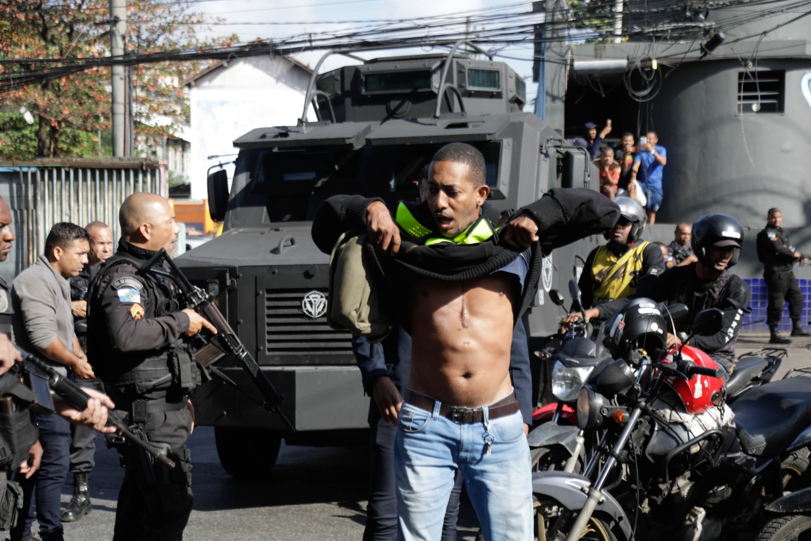 Morador do Complexo do Alemão é revistado por policiais durante operação — Foto: Gabriel de Paiva / Agência O Globo