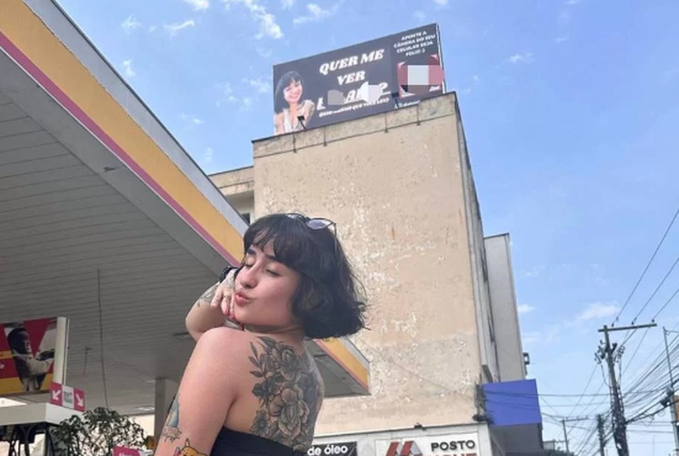 Martina posa com outdoor ao fundo com propaganda sua — Foto: Reprodução