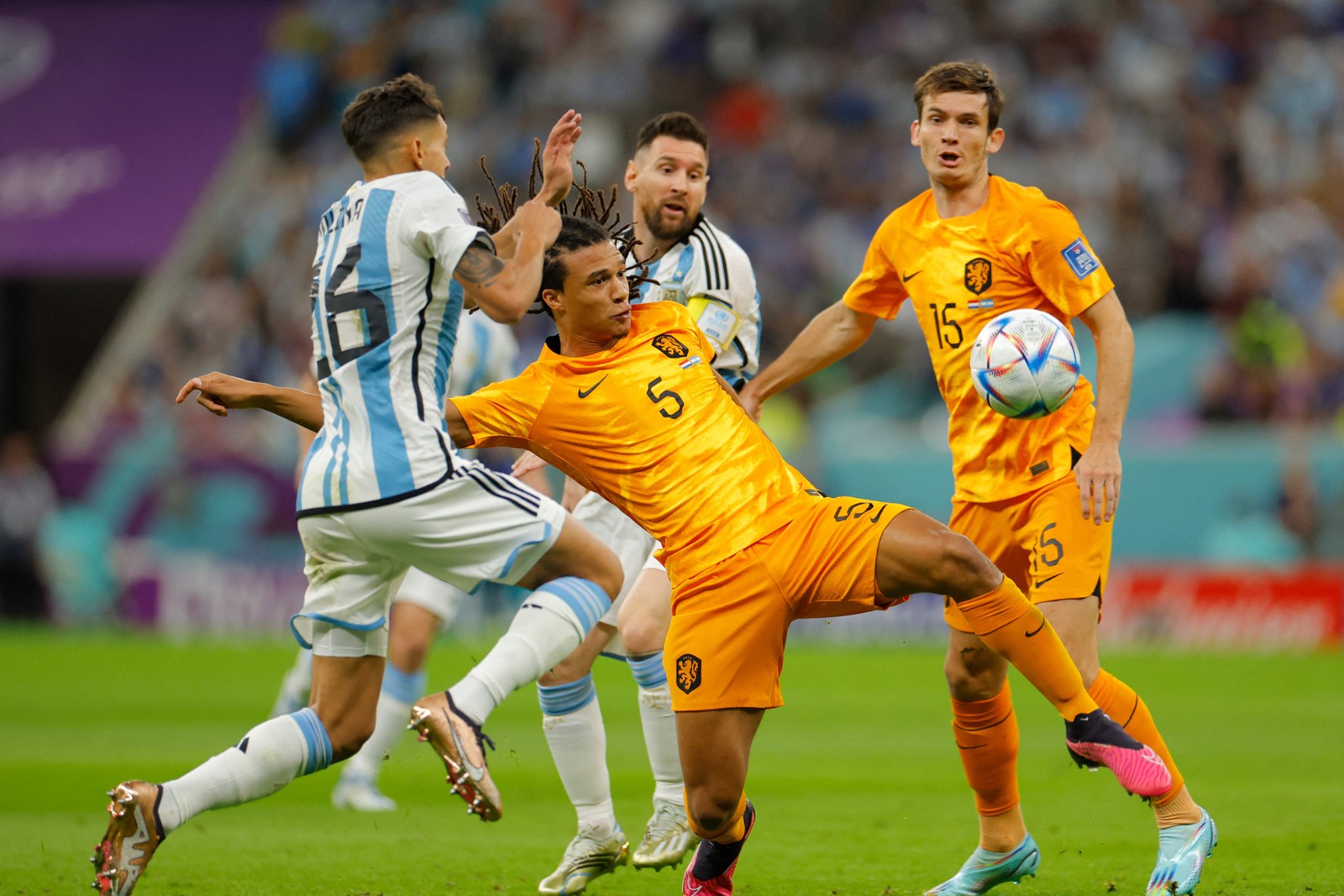 O zagueiro argentino Nahuel Molina tenta roubar a bola do holandês Nathan Ake  — Foto: Odd ANDERSEN / AFP