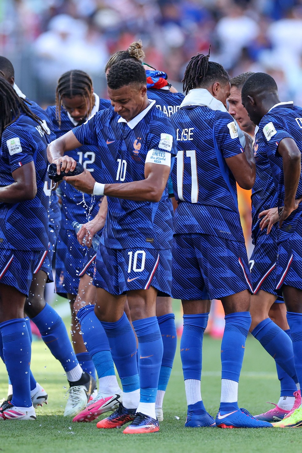 Mbapp&eacute; e outros jogadores da Fran&ccedil;a recorrem a toalhas molhadas para amenizar o calor no est&aacute;dio da Filad&eacute;lfia &mdash; Foto: Dan Mullan / Getty Images via AFP