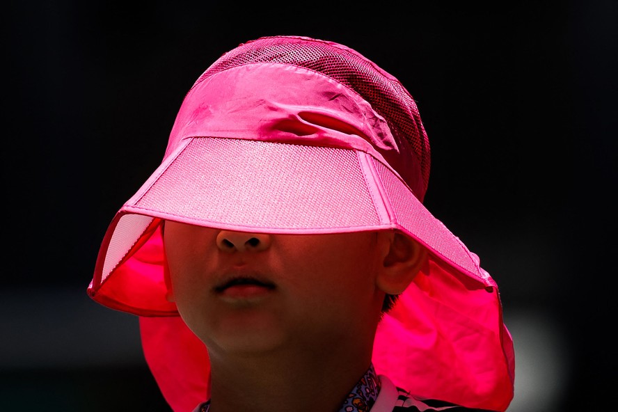 Criança usa um chapéu durante uma onda de calor em Hong Kong