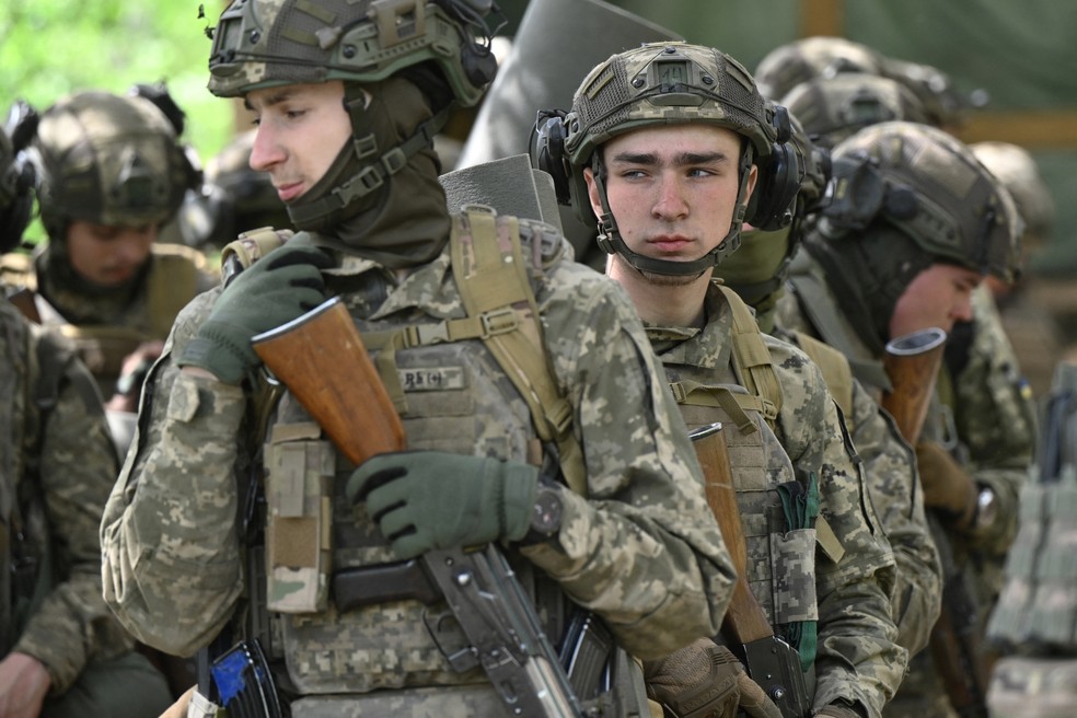 Jovens membros da 28ª Brigada Mecanizada Separada, recrutados sob um novo modelo de serviço militar voluntário 'Contrato 18-24', participam de um exercício de treinamento tático de campo na região de Donetsk, em 1 de maio de 2025, em meio à invasão russa da Ucrânia — Foto: Genya Savilov / AFP