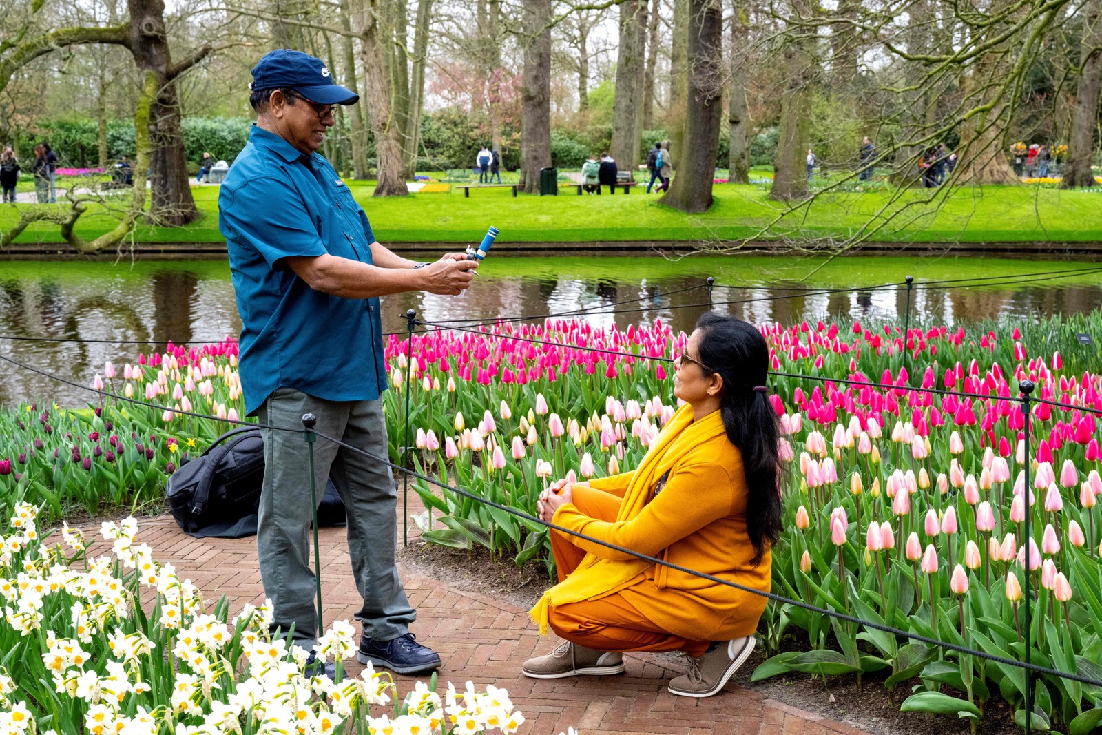 A couple poses for a photo in front of the tulip garden at Keukenhof Gardens in Lisse, near Amsterdam, Netherlands — Photo: Nick Gammon/AFP