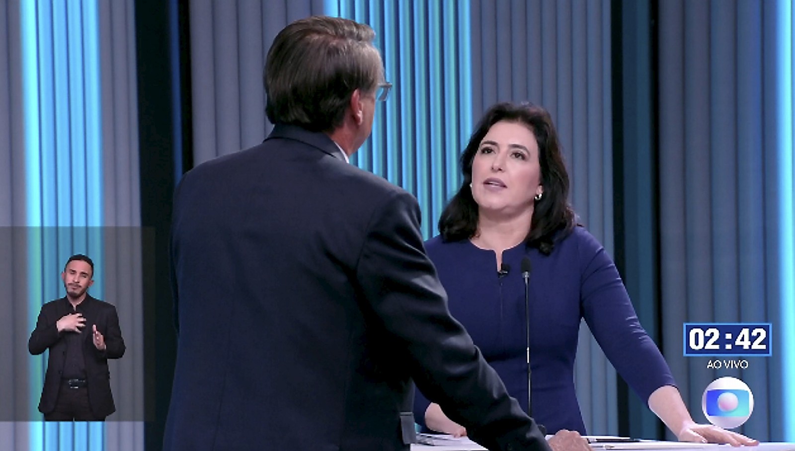 Simone Tebet e Bolsonaro durante o debate da TV Globo nesta quinta-feira (29) — Foto: Reprodução