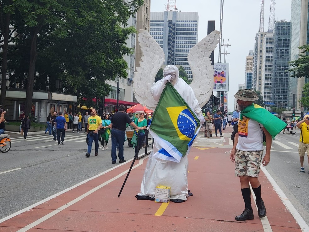 A Bolsonaro protester interacts with a street artist with an Israeli flag, on Av. Paulista (November 26) — Photo: Hyndara Freitas/Agência O Globo