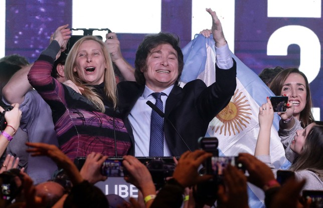 Ao lado da irmã, Karina Milei, o candidato da extrema-direira argentina discursa após vencer as primárias